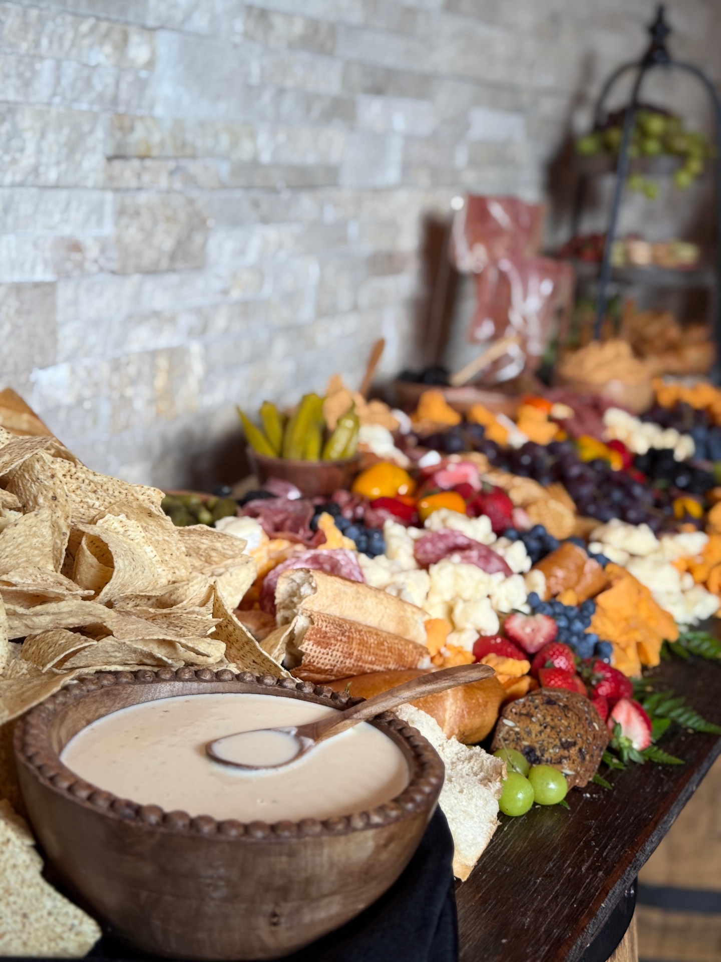 Lavish graze table with charcuterie, cheeses, fruits and house dip