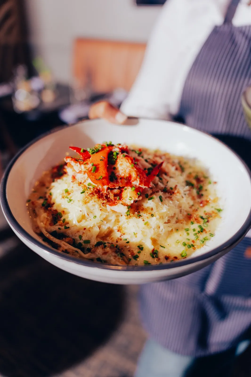 Lobster-topped creamy pasta with toasted breadcrumbs and chives, served at White Wine & Butter in Greer, SC — Cajun restaurant near me