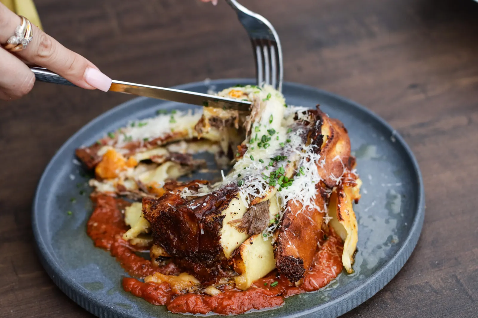 Braised short rib over handmade pasta with pomodoro and grated parmesan — Cajun restaurant near me